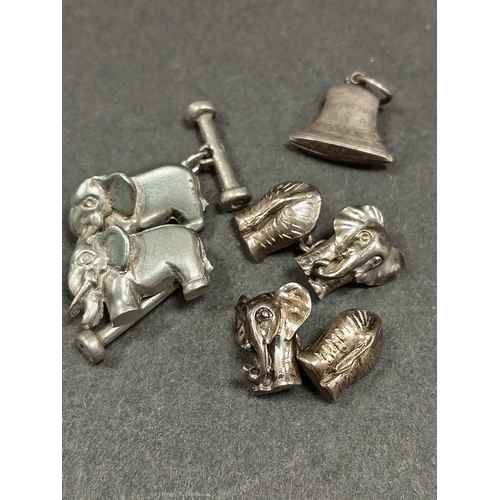 622 - Two pairs of white metal elephant cufflinks and a white metal religious bellcharm