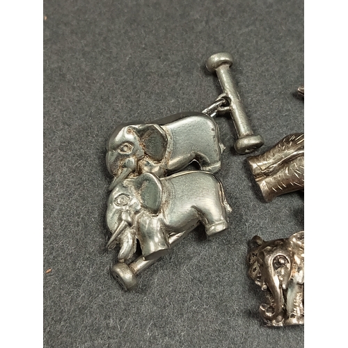 622 - Two pairs of white metal elephant cufflinks and a white metal religious bellcharm