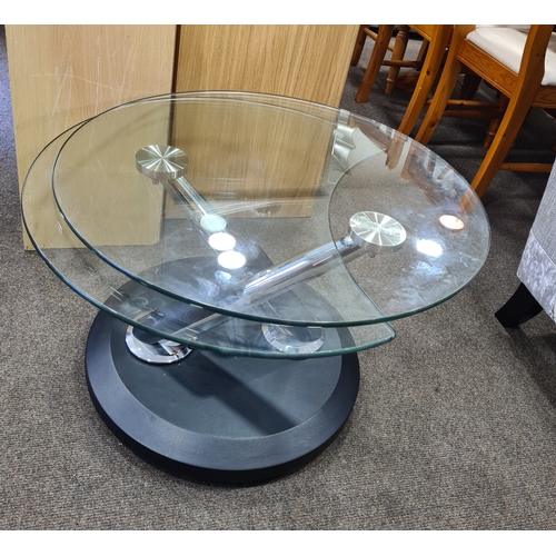 407 - Modern chromed round glass topped twist extendable coffee table which opens to the shape of an 8. H4... 