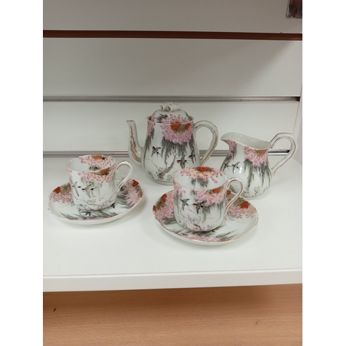 424 - Oriental Chinese teapot, milk jug and a pair of cups and saucers beautifully hand decorated