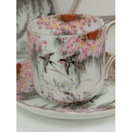 424 - Oriental Chinese teapot, milk jug and a pair of cups and saucers beautifully hand decorated