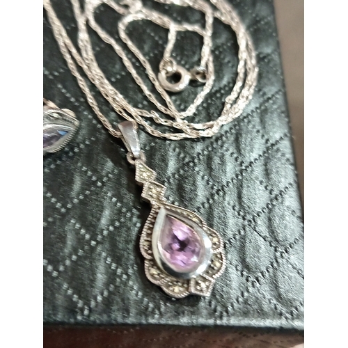 615 - 925 silver Amethyst coloured stone and marcasite pendant on chain L 52cm with matching earrings boxe... 