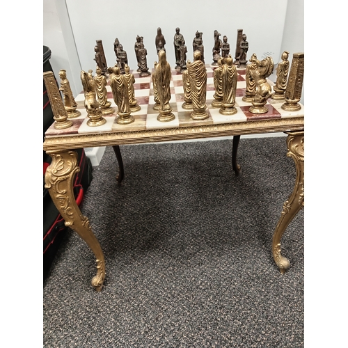 455 - Ornate brass and onyx chess table with full set of Roman brass chess pieces H 45cm x W 50cm