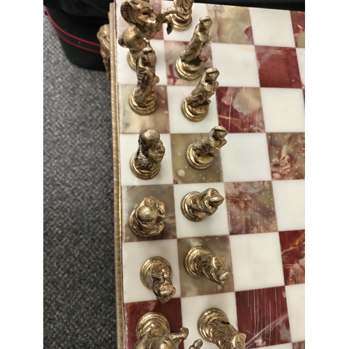 455 - Ornate brass and onyx chess table with full set of Roman brass chess pieces H 45cm x W 50cm