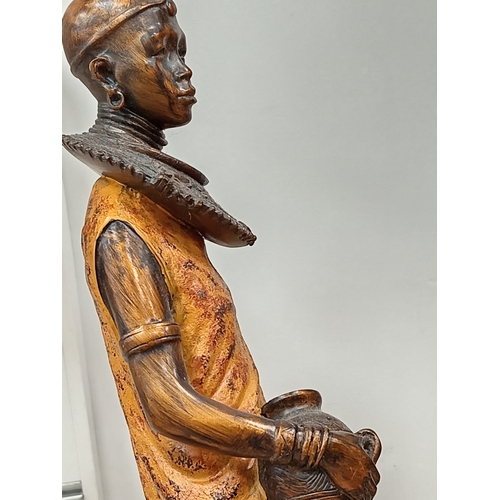 471 - Pair of African decorative lady figures one with child H 43cm x W 10cn and H 40cm x W 9cm