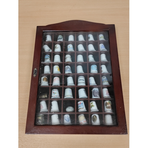 493 - Thimble wall display cabinet. Full of ceramic and metal thimbles from towns, countries and attractio... 