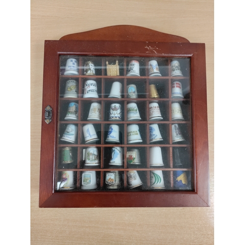 501 - Thimble wall display cabinet. Full of ceramic and metal thimbles from towns and countries.