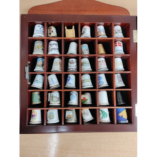 501 - Thimble wall display cabinet. Full of ceramic and metal thimbles from towns and countries.