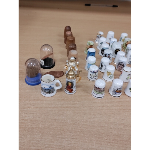 503 - Job lot of thimbles. Ceramic, pewter, wood and pressed coins