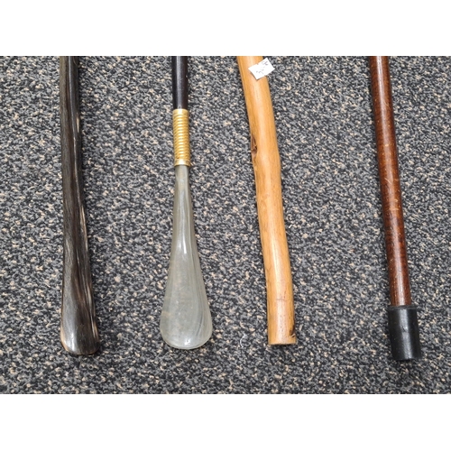 529 - Collection of 2 walking sticks and 2 shoe horns. Includes hallmarked silver collered stick and model... 