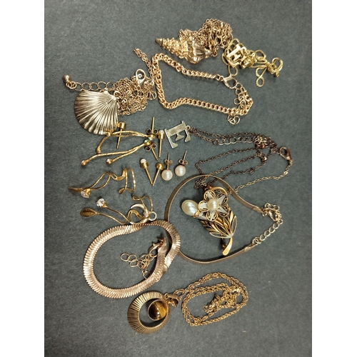 676 - Job lot of yellow metal jewellery includes bracelets necklaces, one with tiger eye pendant and earri... 