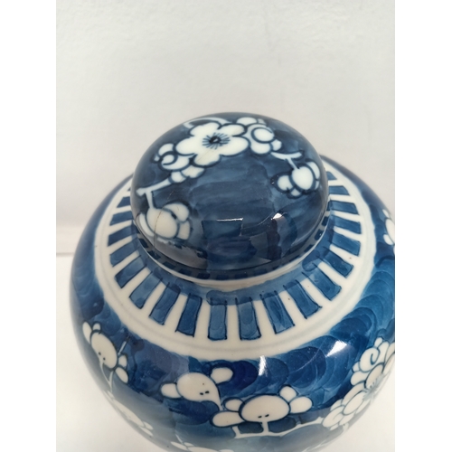 406 - Oriental Chinese blue and white prunus ginger jar on carved wooden stand H 19cm x W 13cm damage to l... 