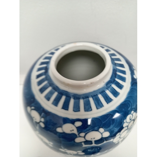 406 - Oriental Chinese blue and white prunus ginger jar on carved wooden stand H 19cm x W 13cm damage to l... 