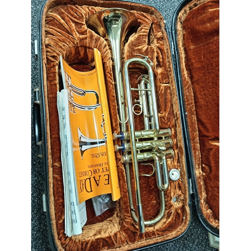 422 - Corton brass trumpet in original velvet lined case with music sheet books included