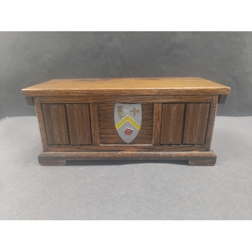 455 - Tallent of Old Bond Street musical box with a coat of arms on the front. H 8cm x W 18.5cm x D 8cm