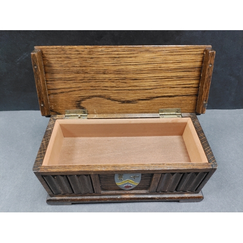 455 - Tallent of Old Bond Street musical box with a coat of arms on the front. H 8cm x W 18.5cm x D 8cm