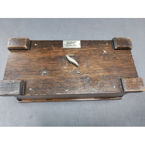 455 - Tallent of Old Bond Street musical box with a coat of arms on the front. H 8cm x W 18.5cm x D 8cm