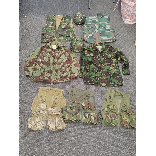 461 - A job lot of military gear. To include 2 camouflage jackets, 3 webbing vests, 1 camouflage vest, 1 s... 