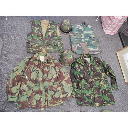 461 - A job lot of military gear. To include 2 camouflage jackets, 3 webbing vests, 1 camouflage vest, 1 s... 