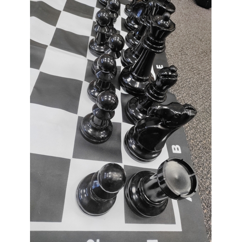 417 - Complete VERY large plastic chess set. Small tear on D,1.  Board H 90cm x W 90cm