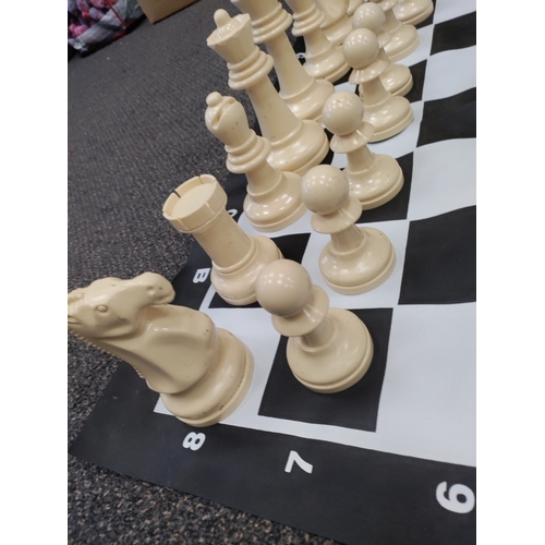 417 - Complete VERY large plastic chess set. Small tear on D,1.  Board H 90cm x W 90cm