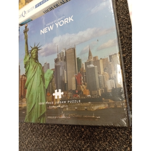 420 - Four sealed jigsaw puzzles includes Statue of liberty New York, Clemontoni, Abbey Road London and Sh... 