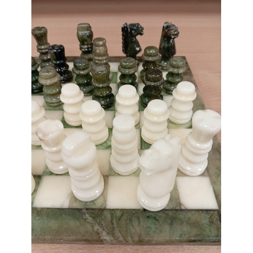 440 - Marble miniature chess board with full chess set pieces 24cm x 24cm