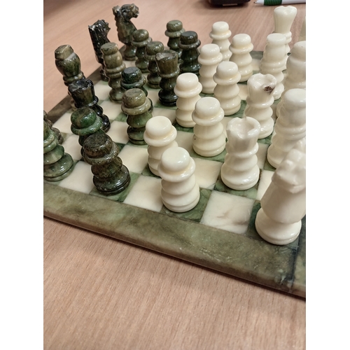 440 - Marble miniature chess board with full chess set pieces 24cm x 24cm