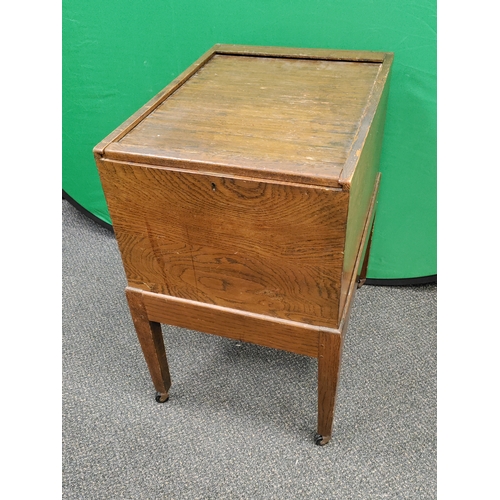 478 - Mid Century Oak tambour top filing cabinet on wheel base with original key