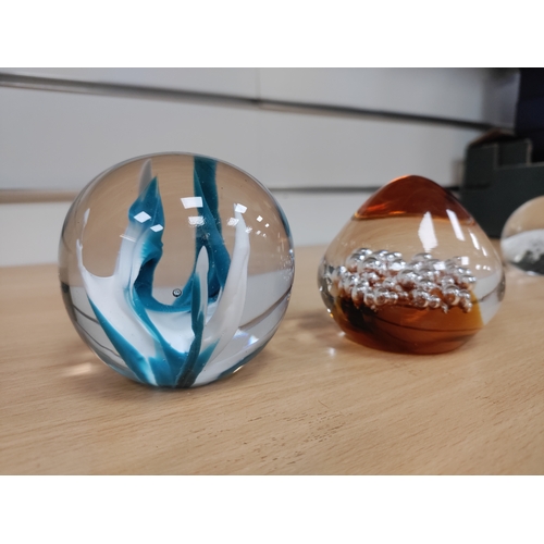 579 - Two glass paper weights one orange and the other blue and white