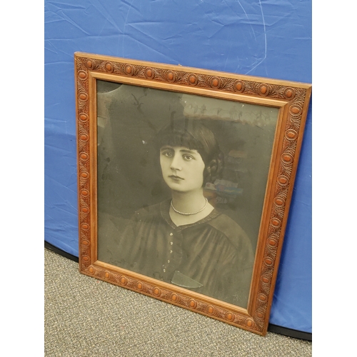 590 - A antique French photo of a woman in a carved wood frame. Glass broken in top left corner.