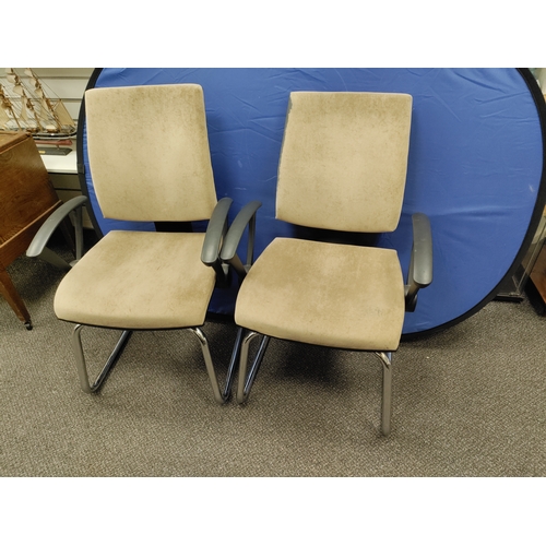 593 - A pair of beige office chairs.