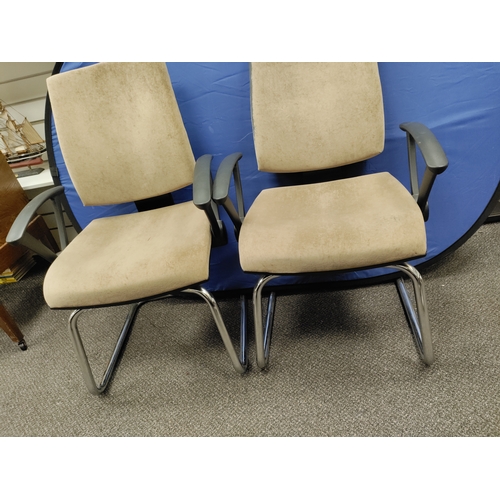 593 - A pair of beige office chairs.