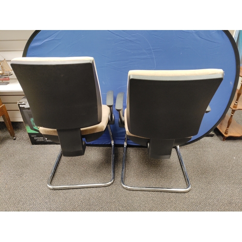 593 - A pair of beige office chairs.