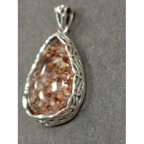 695 - White metal celtic pendant with dried flowers in resin. 3cm