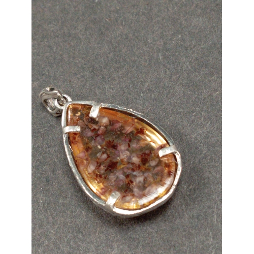 695 - White metal celtic pendant with dried flowers in resin. 3cm