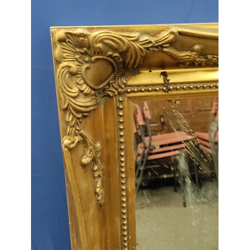 638 - A ornate gold gilt frame mirror. H 92cm x W 65cm