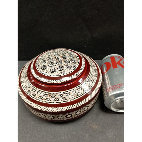 490 - Mother of pearl inlaid wooden ethnic jewellery box. 18cm diameter