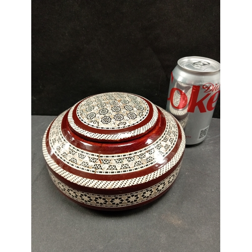 490 - Mother of pearl inlaid wooden ethnic jewellery box. 18cm diameter