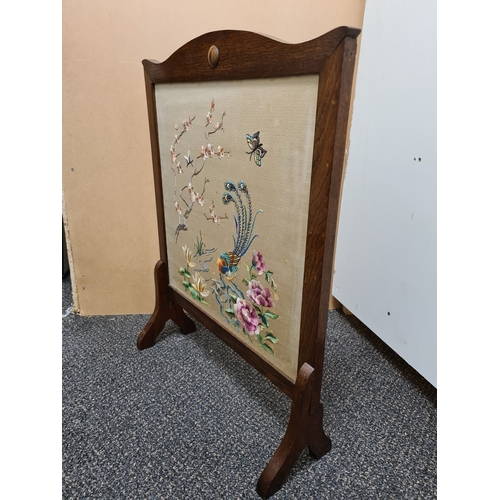 510 - Wooden fire screen guard with embroidered South Asian pattern of peacock & flowers. Measures H69cm x... 