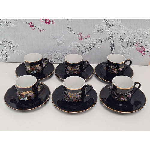 513 - Japanese black floral painted coffee set to include 6 cups with saucers. One cup AF