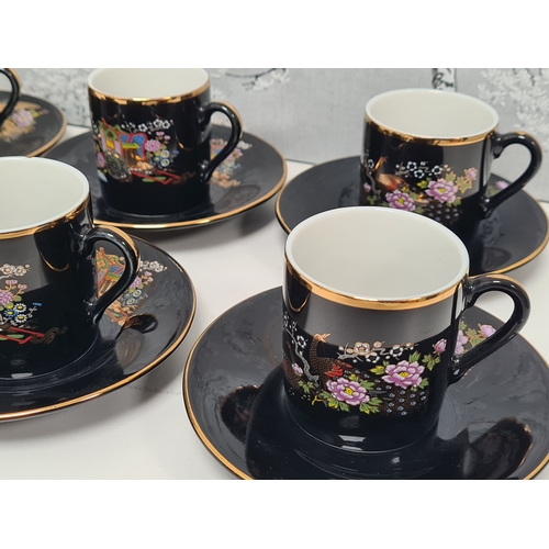 513 - Japanese black floral painted coffee set to include 6 cups with saucers. One cup AF