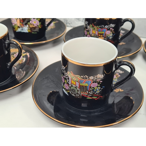 513 - Japanese black floral painted coffee set to include 6 cups with saucers. One cup AF