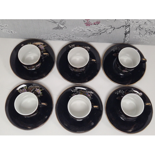 513 - Japanese black floral painted coffee set to include 6 cups with saucers. One cup AF