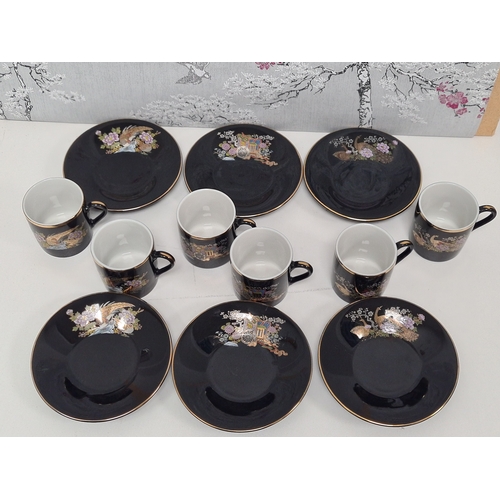 513 - Japanese black floral painted coffee set to include 6 cups with saucers. One cup AF