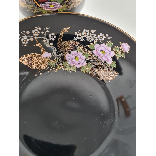 513 - Japanese black floral painted coffee set to include 6 cups with saucers. One cup AF