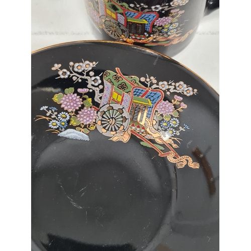 513 - Japanese black floral painted coffee set to include 6 cups with saucers. One cup AF