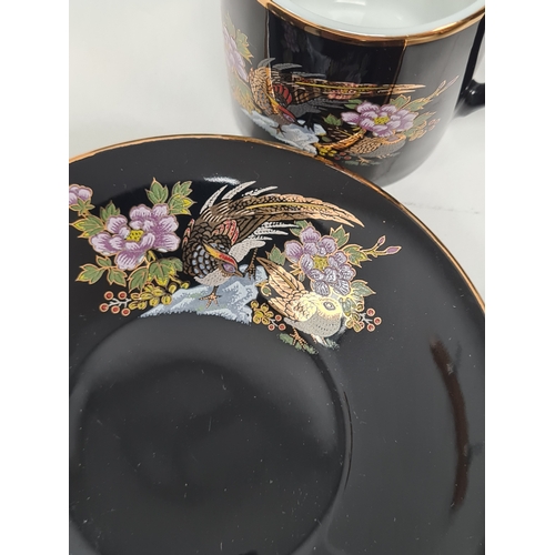 513 - Japanese black floral painted coffee set to include 6 cups with saucers. One cup AF