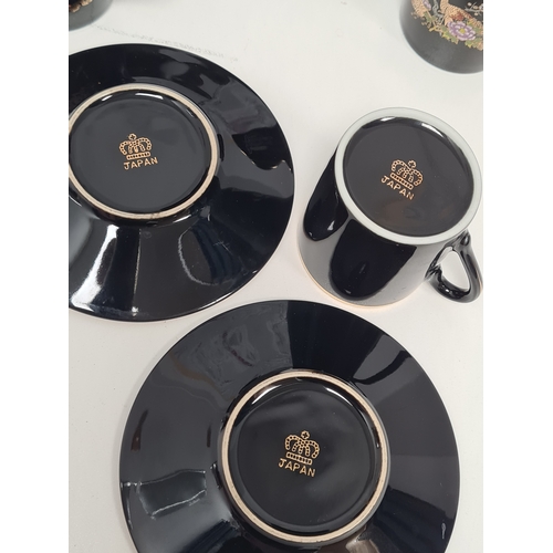 513 - Japanese black floral painted coffee set to include 6 cups with saucers. One cup AF