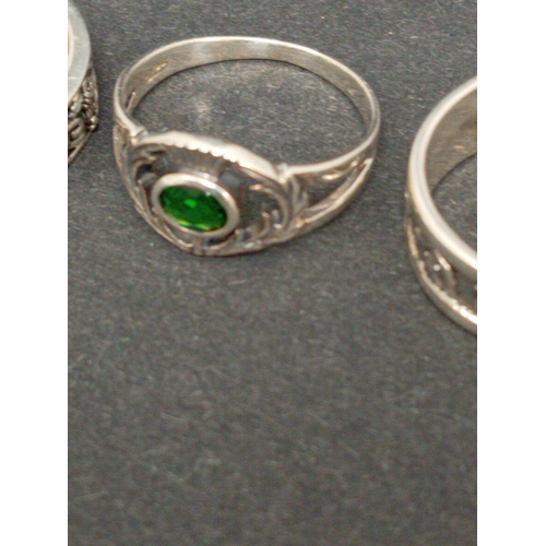 720 - Four 925 silver rings includes two thistle rings one with clear stone, one with green stone and two ... 